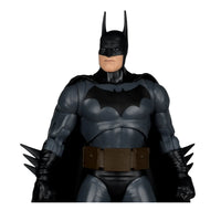 Dark gray and black Batman figure with pointed ears, bat emblem on chest, utility belt, and spiked gauntlets.