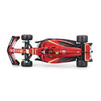 Top view of Bburago 1:43 scale Ferrari SF-24 race car model with Carlos Sainz helmet included