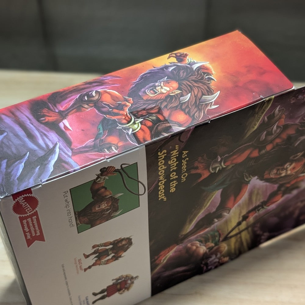 Beast-Man Masters of the Universe Origins Deluxe action figure packaging with artwork by Mattel on wooden surface
