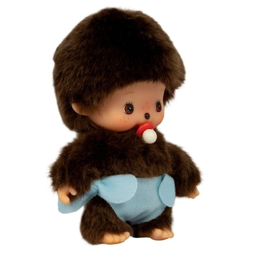 A small plush monkey toy with dark brown fur, a light blue diaper, and a red-and-white pacifier, photographed on a plain white background.