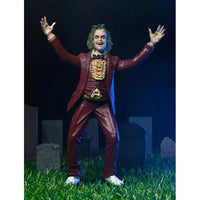 Beetlejuice (1988) Red Tuxedo NECA 7-Inch Scale Action Figure posed with arms raised on grass with tombstones by Neca