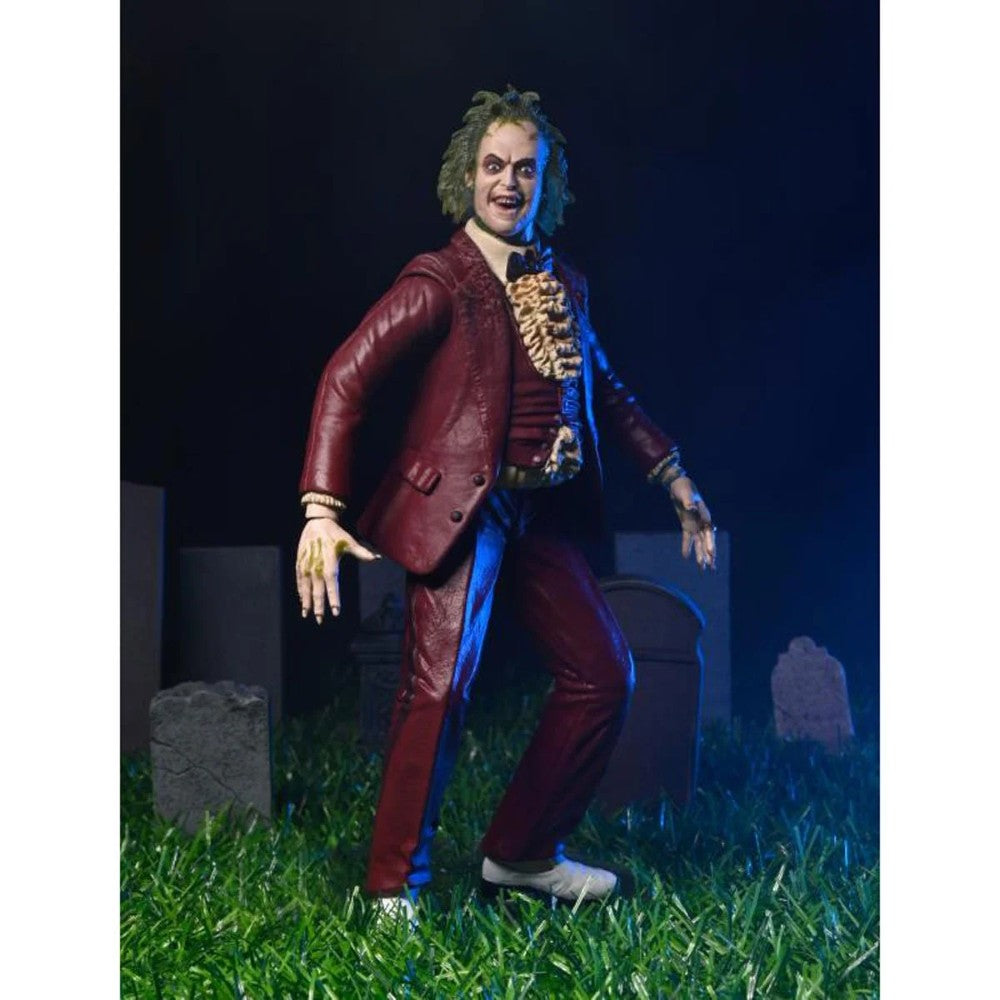 Beetlejuice (1988) Red Tuxedo NECA 7-Inch Scale Action Figure posed on grass with detailed red suit and sculpted hands by Neca