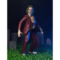 Beetlejuice (1988) Red Tuxedo NECA 7-Inch Scale Action Figure posed on grass with detailed red suit and sculpted hands by Neca