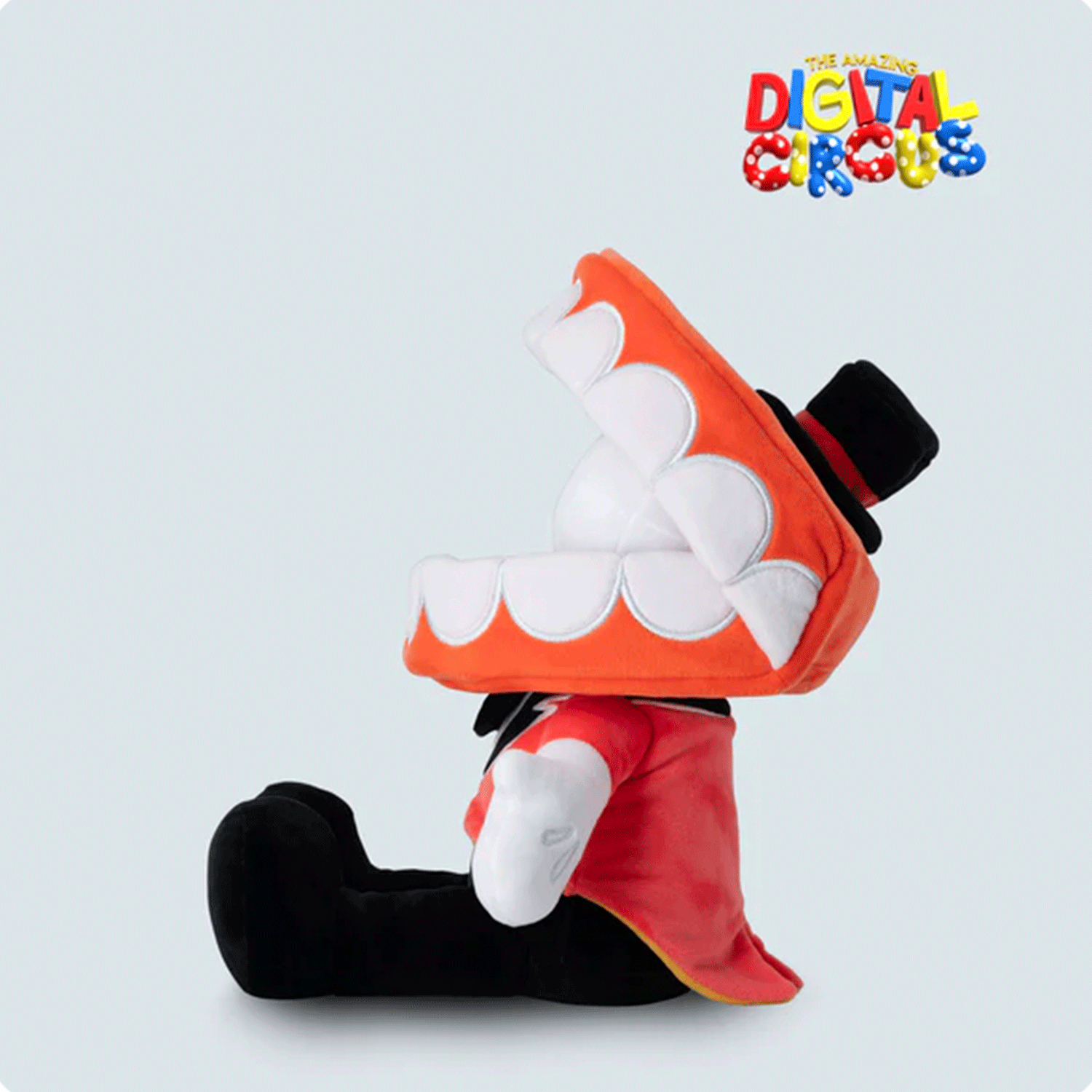 Glitch Caine plush sitting sideways with wide open mouth, black top hat, red jacket, and white glove on light background