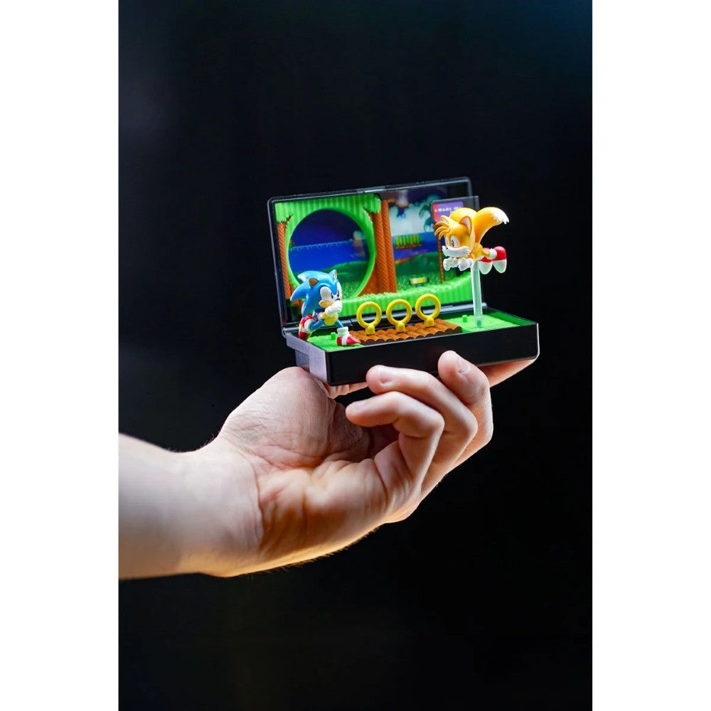 Hand holding Console Heroes Sega Genesis Sonic the Hedgehog 2 Cartridge Diorama Playset with Sonic and Tails figures and rings.
