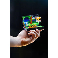 Hand holding Console Heroes Sega Genesis Sonic the Hedgehog 2 Cartridge Diorama Playset with Sonic and Tails figures and rings.