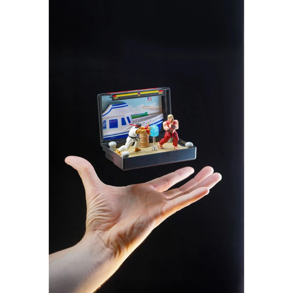 Hand holding Console Heroes Sega Genesis Genesis Street Fighter II Cartridge Diorama Playset with fighting figures and arcade backdrop.