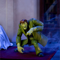 Scooby-Doo Creeper 1:12 scale action figure by Jada Toys in signature green coat posed on red carpet.