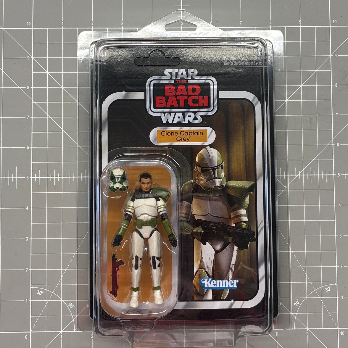 Star Wars The Bad Batch figures in clear blister packaging on a gridded cutting mat