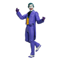Joker action figure in a purple suit with green hair and raised hands