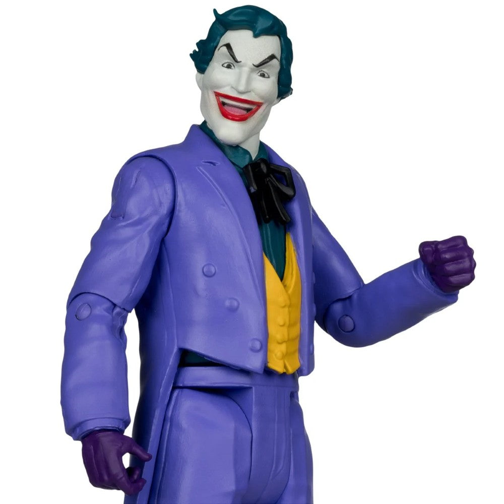 Joker action figure wearing a purple suit with one raised fist