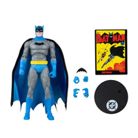 Batman action figure with blue and gray suit, alternate hands, bat emblem, comic cover, and display stand