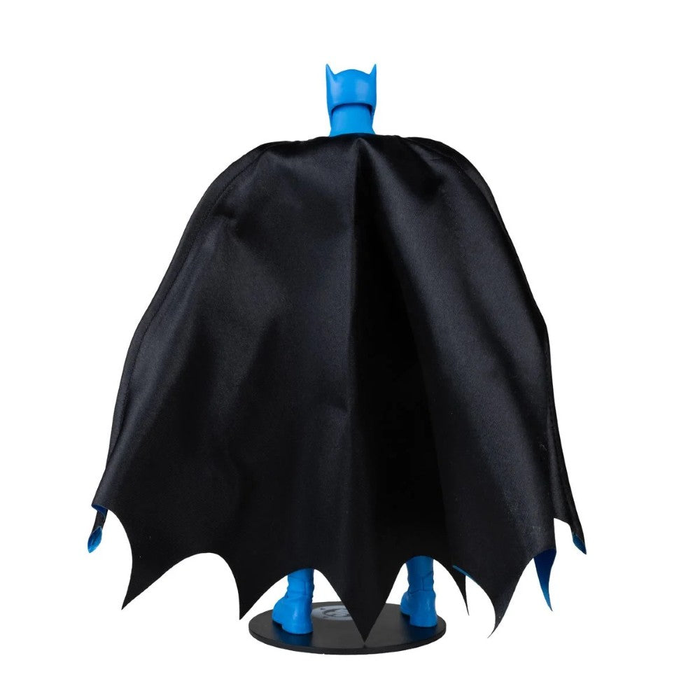 Batman figure in a black cape with blue cowl and boots on a display stand