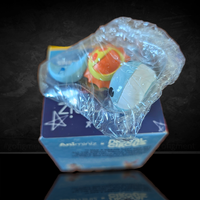 Bubble figure from The Amazing Digital Circus Animiniz series by Glitch in protective plastic bag over box