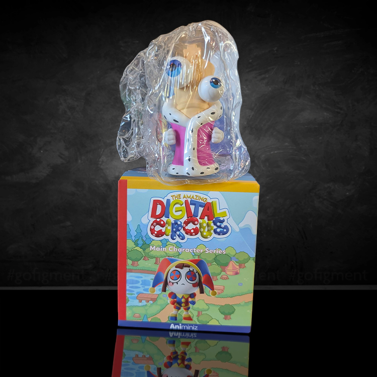 Colorful Digital Circus Animiniz figure in protective plastic standing on its illustrated character series box against dark background