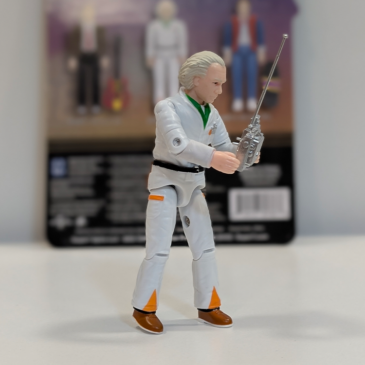 Super7 Back To The Future 3 3/4-inch Doc Brown figure in white jumpsuit holding remote with packaging backdrop