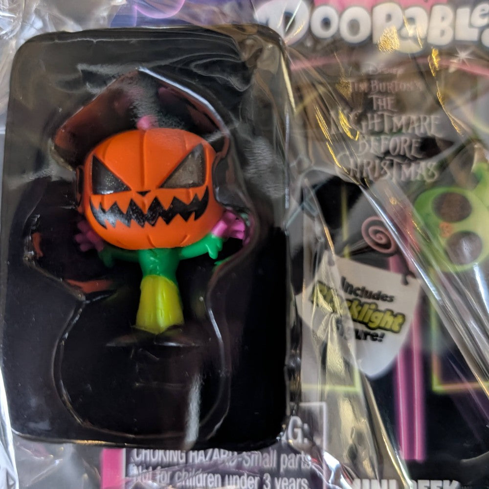 Go Figment Disney Doorables mini-figure featuring Halloween pumpkin character from Tim Burton's The Nightmare Before Christmas black light series