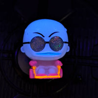 Go Figment Disney Doorables black light mini-figure with glitter lenses and glowing pink and orange neon chair under dark lighting