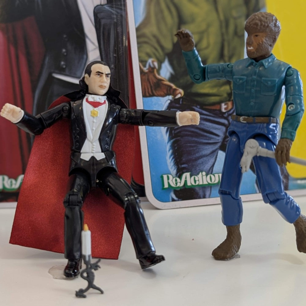 Universal Monsters 3 3/4 inch Wolf Man and Dracula ReAction figures posed with packaging in background by Hasbro