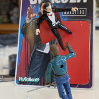 Universal Monsters Dracula Reaction+ 3 3/4-inch action figure by Hasbro posed with another figure on table