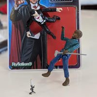 Universal Monsters Dracula 3 3/4-inch ReAction+ figure by Hasbro with Wolfman figure and candlestick on table