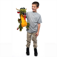 Boy holding Silly Puppet Green Dragon Puppet with Movable Mouth by Silly Puppets, showcasing playful green dragon design