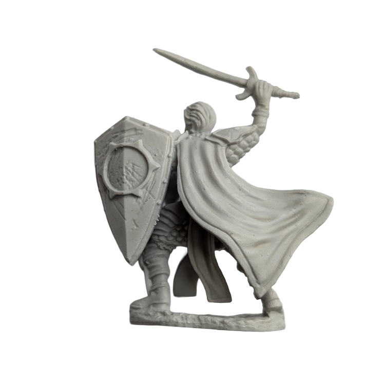 Unpainted miniature fantasy warrior figure holding a sword and shield with a flowing cape from the back view