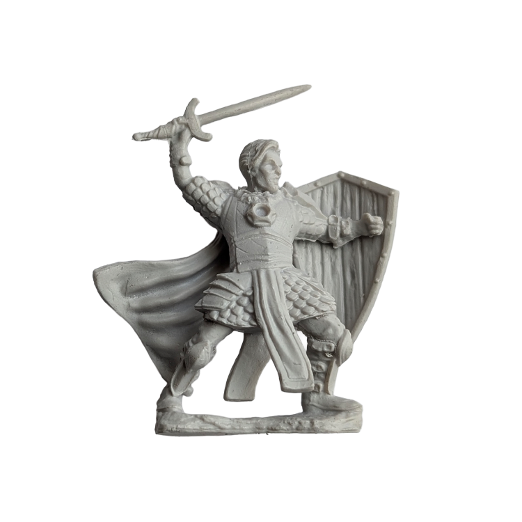 Unpainted miniature figurine of a medieval knight holding a sword and shield in a battle pose