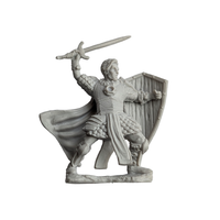 Unpainted miniature figurine of a medieval knight holding a sword and shield in a battle pose