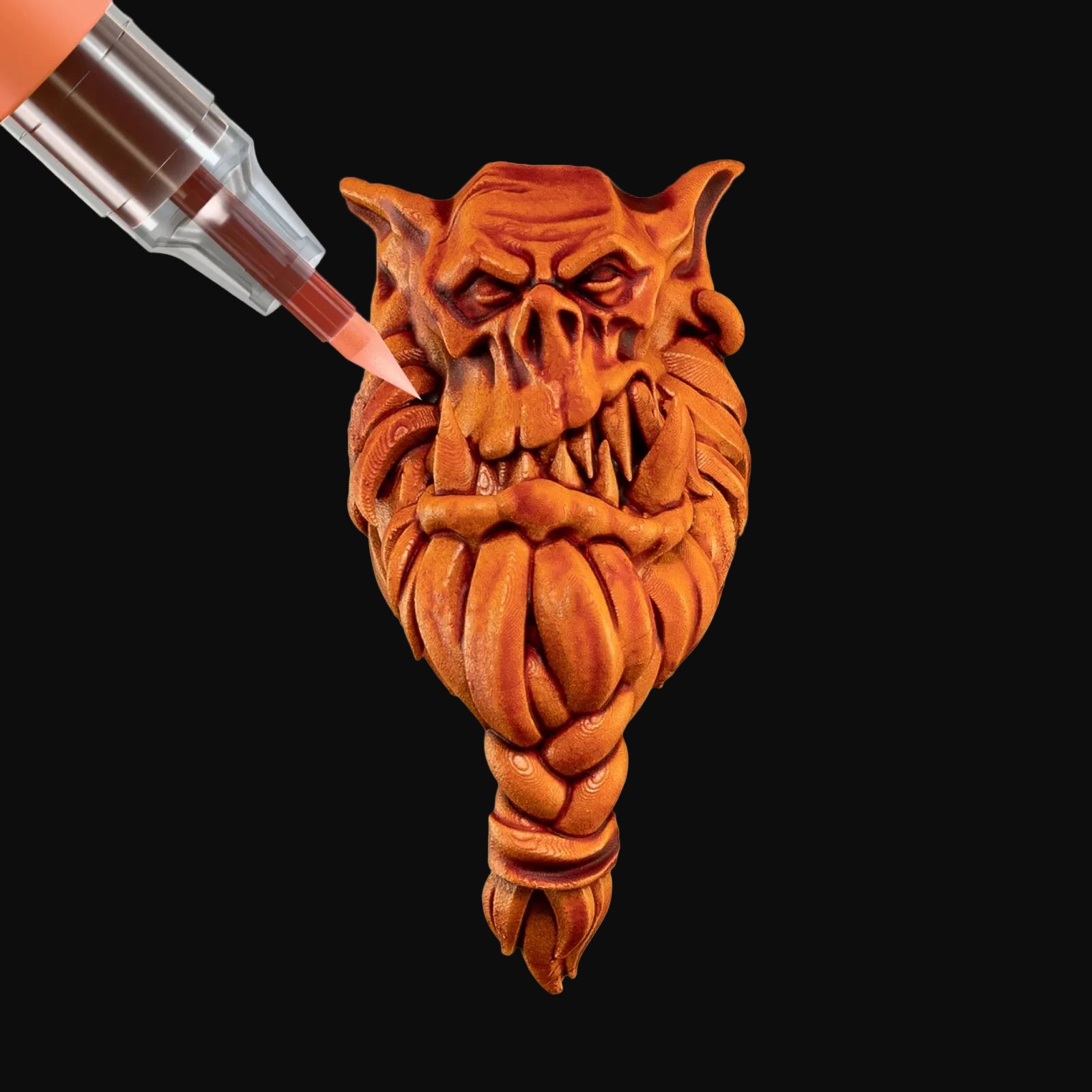 Paint being applied to a carved wooden face with a white background