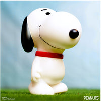Funko Peanuts Snoopy vinyl figure standing upright with a red collar and cheerful expression on grass background