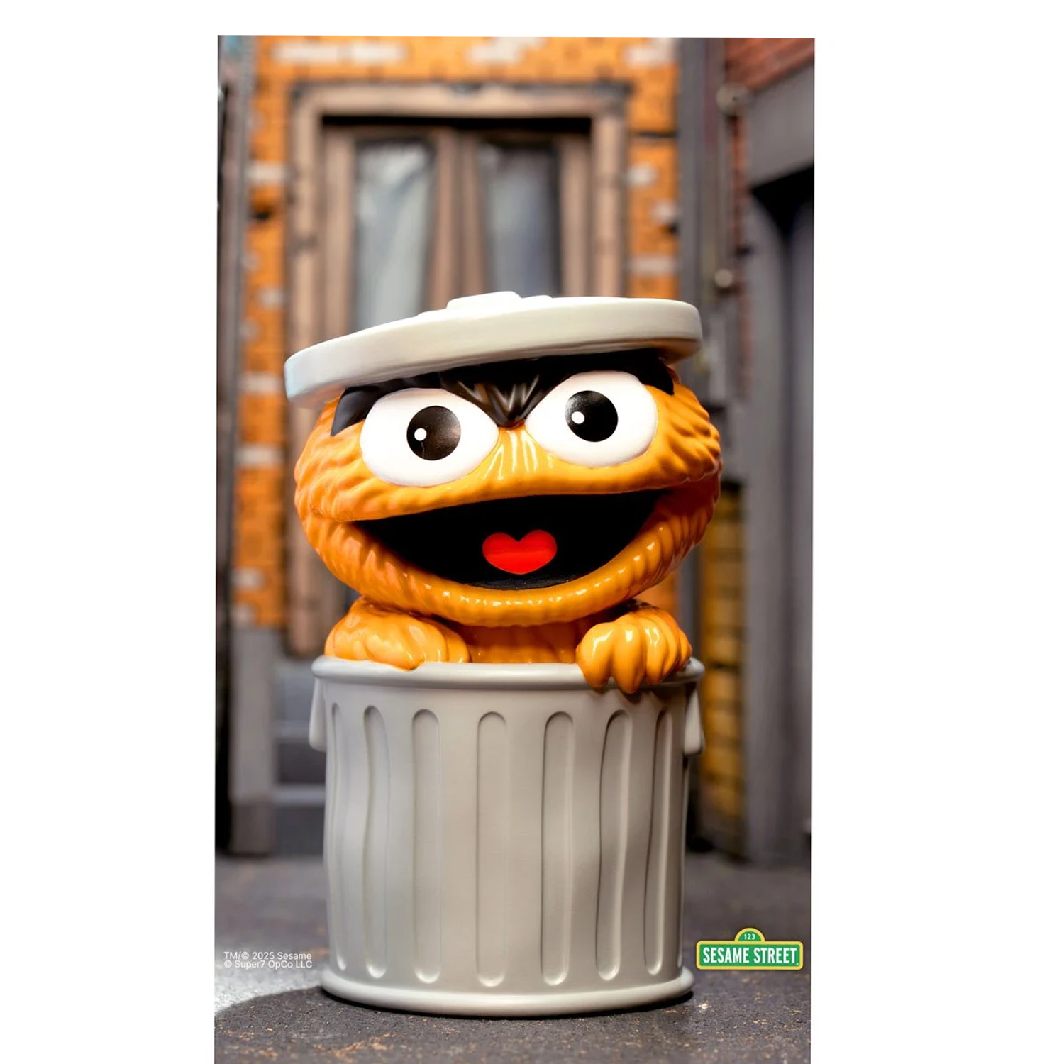 Sesame Street Oscar the Grouch (Orange) FUN! FUN! Vinyl Figure peeking out of a silver trash can with brick background.