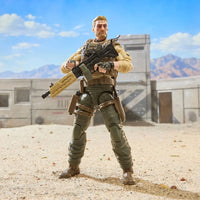 Military action figure holding a rifle in a sunlit desert setting