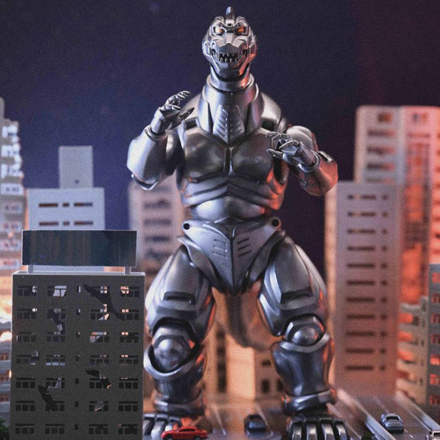 Robotic dinosaur figure with dark metallic armor posed among miniature city buildings under dim blue lighting.