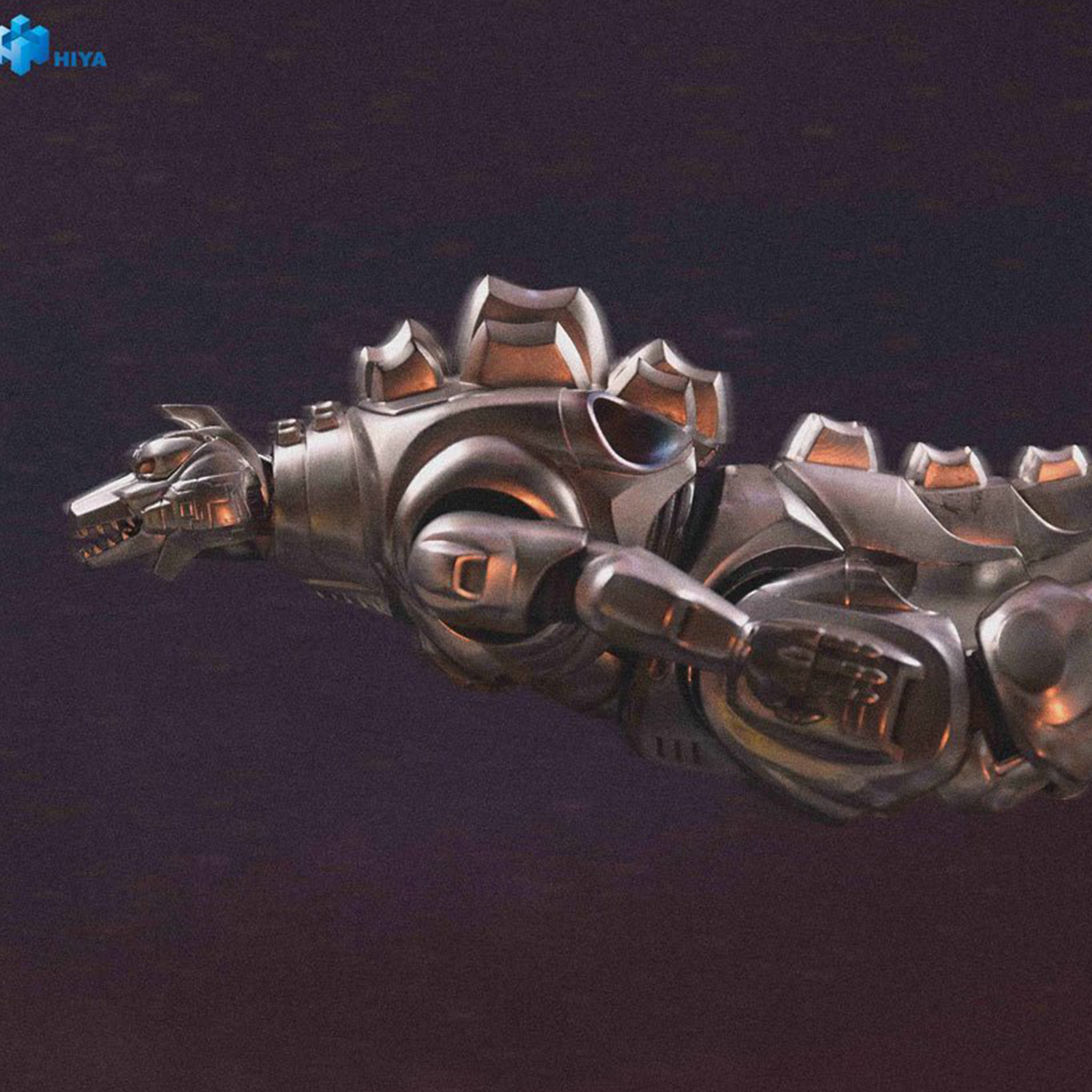 Metallic silver robotic dinosaur figure resembling Mechagodzilla with detailed armor plating on dark background.