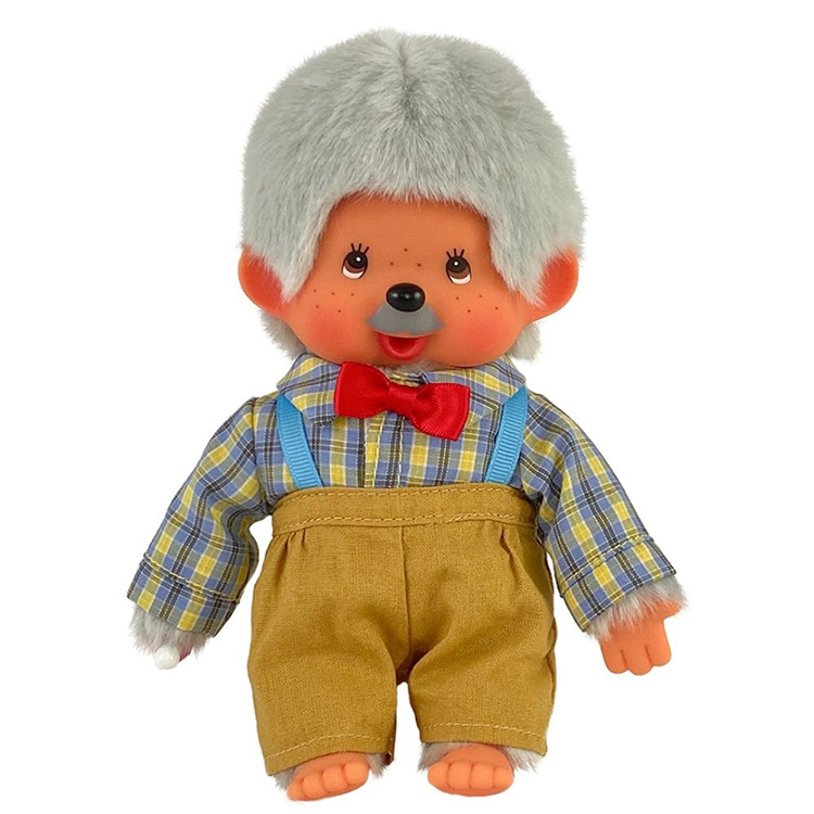 Vintage style Monchhichi doll with gray hair, red bow tie, plaid shirt, and brown overalls on white background