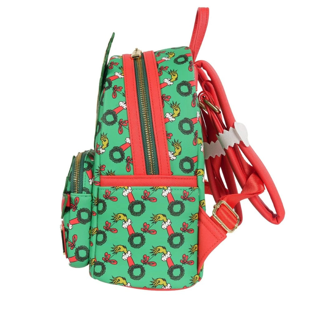 Loungefly How the Grinch Stole Christmas green mini-backpack with Grinch wreath pattern and red straps side view