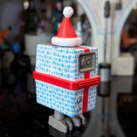 Hasbro Gronk Blue Christmas Present Droid action figure decorated with snowflakes and red Santa hat holiday design