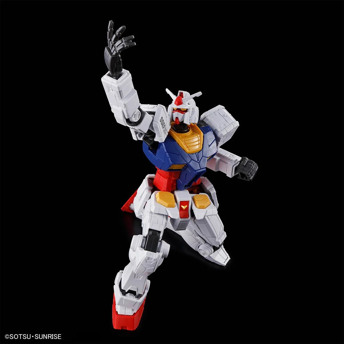 Articulated white, blue, and red Gundam figure posed dynamically against a black background with detailed armor panels