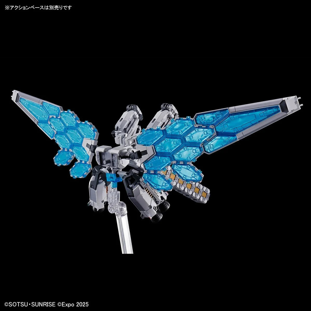 Mechanical model with large translucent blue hexagonal wings and gray detailed body on display stand against black background