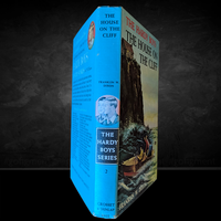 Vintage 1959 Hardy Boys book The House on the Cliff with iconic Rudi Nappi cover and blue spine by Grosset & Dunlap