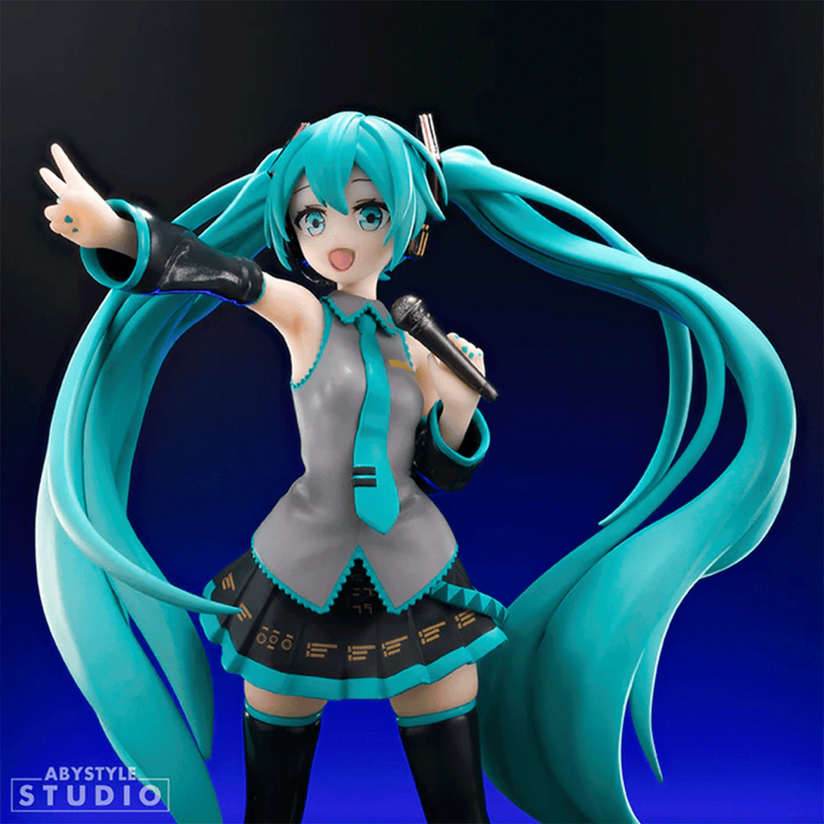 Abysse dynamic 1:10 scale Hatsune Miku statue with long twin tails holding microphone in energetic pose on dark background