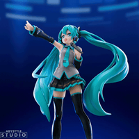 Dynamic Abysse 1:10 scale Hatsune Miku statue with flowing teal twin tails and microphone in energetic singing pose on blue background