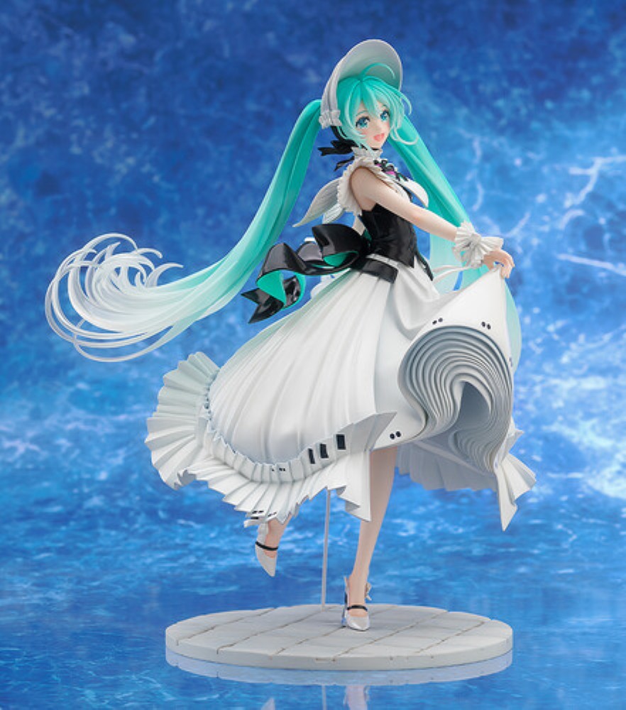Turquoise-haired anime figurine in a flowing white dress on a display stand against a blue background