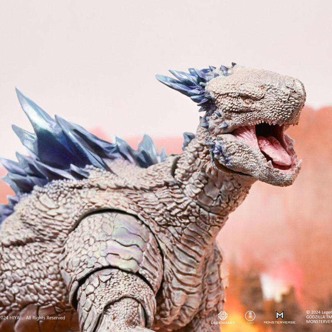 Hiya Toys Shimo Godzilla action figure with detailed scales and blue dorsal plates roaring against a blurred background