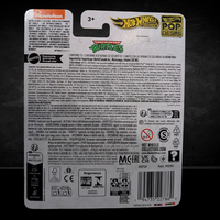 Back packaging of Hot Wheels Premium TMNT Party Wagon diecast car with safety and import information