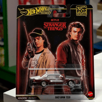 Mattel Hot Wheels 1983 BMW 733i Stranger Things Pop Culture 2026 die-cast car with character art packaging front view