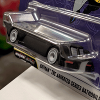 Mattel Hot Wheels metallic silver Batmobile die-cast vehicle from Batman Animated Series in clear packaging side angle view