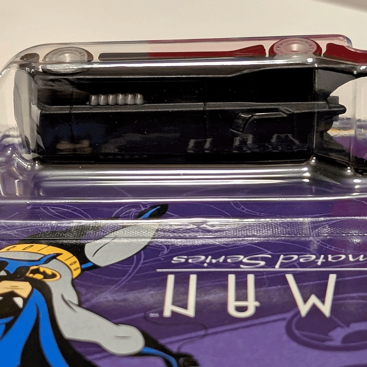 Mattel Hot Wheels Animated Series Batmobile die-cast vehicle in unopened purple packaging side view