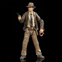 Hasbro Indiana Jones Adventure Series action figure holding gun and whip in classic explorer outfit on black background
